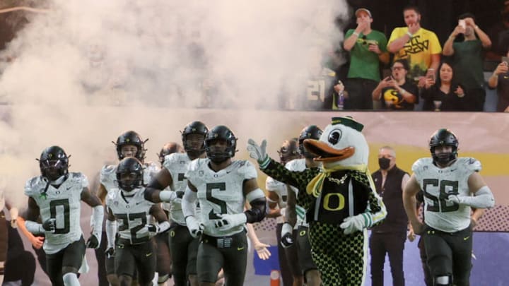 LAS VEGAS, NEVADA - DECEMBER 03: Defensive end Kayvon Thibodeaux #5 of the Oregon Ducks and the Ducks mascot The Duck lead the team onto the field for the Pac-12 Conference championship game against the Utah Utes at Allegiant Stadium on December 3, 2021 in Las Vegas, Nevada. The Utes defeated the Ducks 38-10. (Photo by Ethan Miller/Getty Images)