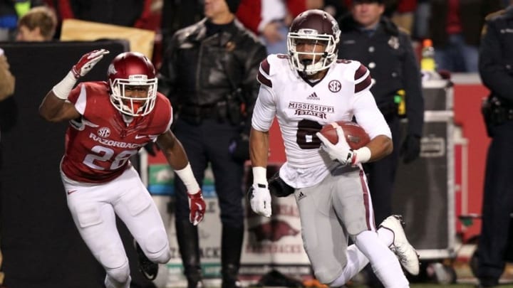 Nov 21, 2015; Fayetteville, AR, USA; Mississippi State Bulldogs wide receiver Fred Ross (8) after a catch, runs for a touchdown as Arkansas Razorbacks defensive back Josh Liddell (28) looks on at Donald W. Reynolds Razorback Stadium. Mandatory Credit: Nelson Chenault-USA TODAY Sports