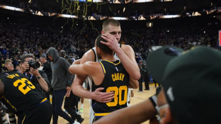 Apr. 27, 2022; San Francisco, California, USA; Denver Nuggets center Nikola Jokic (15) and Golden State Warriors guard Stephen Curry (30) hug after game five of the first round for the 2022 NBA playoffs at Chase Center. (Cary Edmondson-USA TODAY Sports)