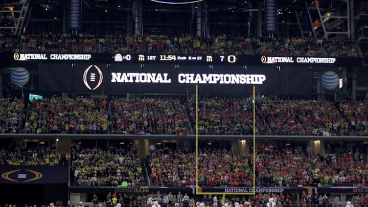 ARLINGTON, TX - JANUARY 12: quarterback Marcus Mariota #8 of the Oregon Ducks takes a snap in the first quarter against the Ohio State Buckeyes during the College Football Playoff National Championship Game at AT&T Stadium on January 12, 2015 in Arlington, Texas. (Photo by Jamie Squire/Getty Images)