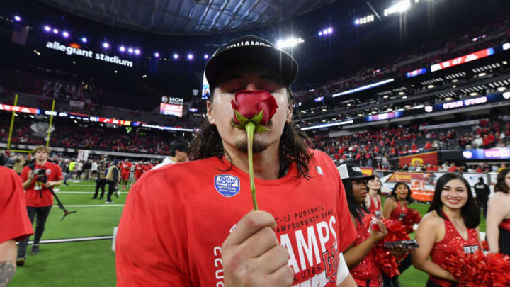 LAS VEGAS, NEVADA - DECEMBER 02: Cameron Rising #7 of the Utah Utes smells a rose after the PAC-12 Championship football game against the USC Trojans at Allegiant Stadium on December 02, 2022 in Las Vegas, Nevada. The Utah Utes won 47-24. (Photo by Alika Jenner/Getty Images)