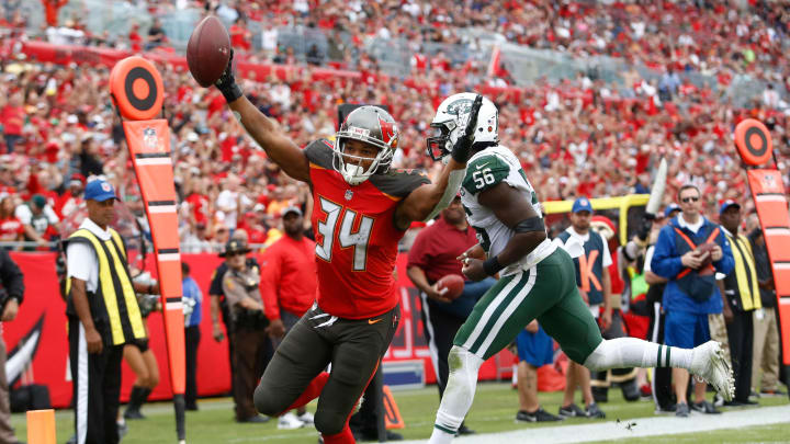 TAMPA, FL – NOVEMBER 12: Running back Charles Sims #34 of the Tampa Bay Buccaneers evades inside linebacker Demario Davis #56 of the New York Jets as he runs into the end zone for a touchdown during the fourth quarter of an NFL football game on November 12, 2017 at Raymond James Stadium in Tampa, Florida. (Photo by Brian Blanco/Getty Images)