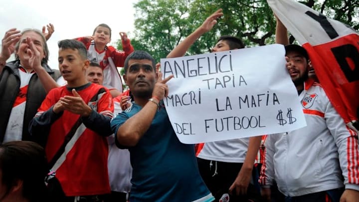 Argentinian River Plate's supporters protest outside the club's stadium in Buenos Aires on December 1, 2018. - River Plate said Saturday they have refused to play the Copa Libertadores final second leg against Boca Juniors in Madrid, casting uncertainty over the December 9 fixture. The match between the Argentine arch-rivals has been moved to Real Madrid's Santiago Bernabeu stadium after it was twice postponed last weekend after River Plate fans attacked the Boca Juniors team bus. (Photo by JAVIER GONZALEZ TOLEDO / AFP) (Photo credit should read JAVIER GONZALEZ TOLEDO/AFP/Getty Images)