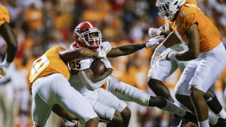 KNOXVILLE, TENNESSEE - OCTOBER 05: Brian Herrien #35 of the Georgia Bulldogs runs with the ball while defended by Nigel Warrior #18 of the Tennessee Volunteers during the fourth quarter at Neyland Stadium on October 05, 2019 in Knoxville, Tennessee. (Photo by Silas Walker/Getty Images)