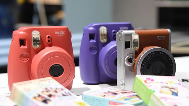 COLOGNE, GERMANY – SEPTEMBER 15: New Fujifilm Instax cameras are displayed at the Photokina 2014 trade fair on September 15, 2014 in Cologne, Germany. Photokina is the world’s largest trade fair for cameras and photographic equipment. (Photo by Marc Pfitzenreuter/Getty Images)