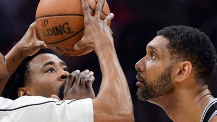 Feb 18, 2016; Los Angeles, CA, USA; Los Angeles Clippers center DeAndre Jordan (6) and San Antonio Spurs center Tim Duncan (21) wait for the jump ball to start the game at Staples Center. Mandatory Credit: Robert Hanashiro-USA TODAY Sports
