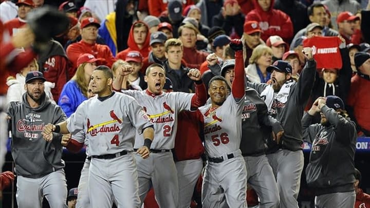 Oct 12, 2012; Washington, DC, USA; Members of the St. Louis Cardinals including Yadier Molina (4) celebrate in the dugout as two runs score against the Washington Nationals during the ninth inning of game five of the 2012 NLDS at Nationals Park. Mandatory Credit: Brad Mills-USA TODAY Sports