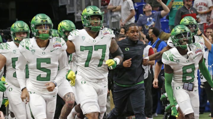 SAN ANTONIO, TX - DECEMBER 29: Oregon Ducks interim head coach Bryan McClendon leads his team onto the field before the start of their game against the Oklahoma Sooners in the Valero Alamo Bowl at the Alamodome on December 29, 2021 in San Antonio, Texas. (Photo by Ronald Cortes/Getty Images)