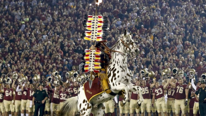 TALLAHASSEE, FL - NOVEMBER 11: Chief Osceola and Renegade of the Florida State Seminoles planet the flaming spear on the 50 yardline before the game against the Boston College Eagles at Doak Campbell Stadium on Bobby Bowden Field on November 11, 2016 in Tallahassee, Florida. Florida State defeated Boston College 45 to 7. (Photo by Don Juan Moore/Getty Images)