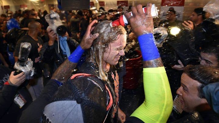 Oct 1, 2016; Philadelphia, PA, USA; New York Mets pitcher Noah Syndergaard (34) is doused by third baseman Jose Reyes (7) after clinching a wild-card playoff berth after a game against the Philadelphia Phillies at Citizens Bank Park. Mandatory Credit: Derik Hamilton-USA TODAY Sports