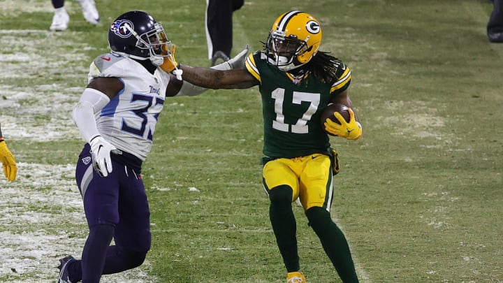 GREEN BAY, WISCONSIN – DECEMBER 27: Wide receiver Davante Adams #17 of the Green Bay Packers is forced out of bounds by free safety Desmond King #33 of the Tennessee Titans during the fourth quarter at Lambeau Field on December 27, 2020 in Green Bay, Wisconsin. (Photo by Stacy Revere/Getty Images)