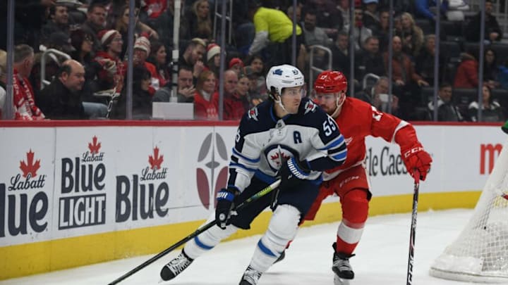 Dec 12, 2019; Detroit, MI, USA; Winnipeg Jets center Mark Scheifele (55) handles the puck as Detroit Red Wings defenseman Filip Hronek (17) defends during the first period at Little Caesars Arena. Mandatory Credit: Tim Fuller-USA TODAY Sports
