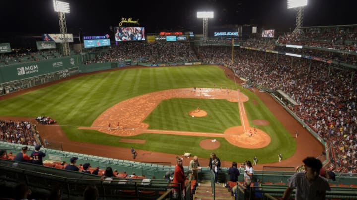 Jul 22, 2021; Boston, Massachusetts, USA; The grounds crew prepares the infield after removing the tarp during the fourth inning in a game between the Boston Red Sox and New York Yankees at Fenway Park. Mandatory Credit: Bob DeChiara-USA TODAY Sports