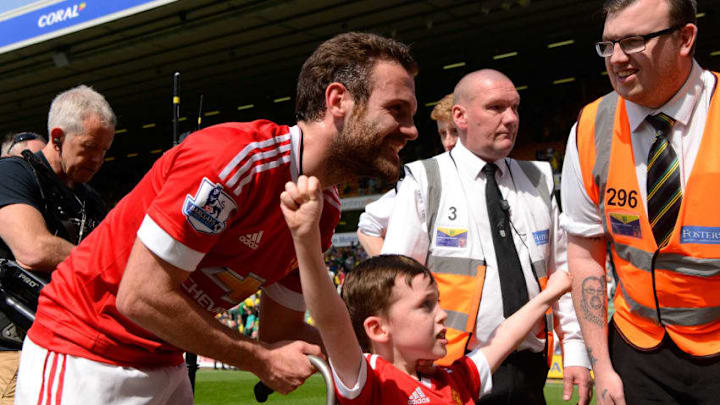 NORWICH, ENGLAND - MAY 07: Juan Mata of Manchester United with a fan celebrate their win after the Barclays Premier League match between Norwich City and Manchester United at Carrow Road on May 7, 2016 in Norwich, England. (Photo by Mike Hewitt/Getty Images)