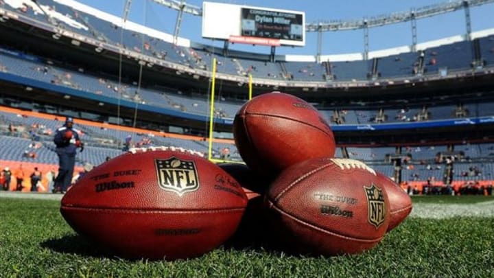 Dec 8, 2013; Denver, CO, USA; General view of the footballs on the ground before the game between the Tennessee Titans and the Denver Broncos at Sports Authority Field at Mile High. Mandatory Credit: Ron Chenoy-USA TODAY Sports