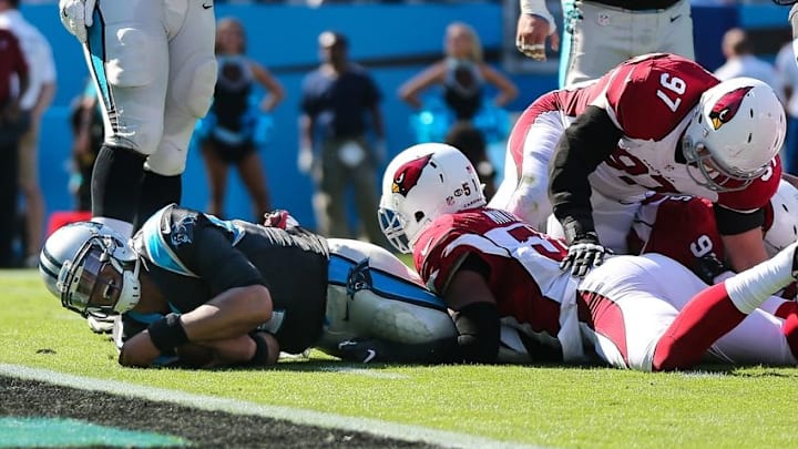 Oct 30, 2016; Charlotte, NC, USA; Carolina Panthers quarterback Cam Newton (1) winces after almost making the goal line tackled by Arizona Cardinals middle linebacker Kevin Minter (51) during the second quarter at Bank of America Stadium. Mandatory Credit: Jim Dedmon-USA TODAY Sports