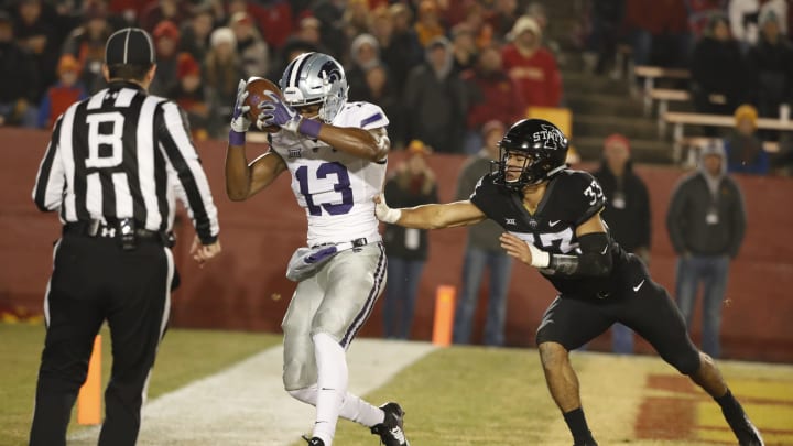 Wide receiver Chabastin Taylor #13 of the Kansas State Wildcats pulls in a touchdown pass as defensive back Braxton Lewis #33 of the Iowa State Cyclones blocks in the second half of play at Jack Trice Stadium on November 24, 2018 in Ames, Iowa. The Iowa State Cyclones won 42-38 over the Kansas State Wildcats. (Photo by David K Purdy/Getty Images)