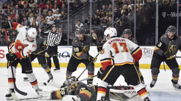 LAS VEGAS, NV - FEBRUARY 21: Alex Tuch #89, Nate Schmidt #88 and Brayden McNabb #3 defend as their teammate goalie Marc-Andre Fleury #29 of the Vegas Golden Knights makes a save against Sean Monahan #23 and Johnny Gaudreau #13 of the Calgary Flames during the game at T-Mobile Arena on February 21, 2018 in Las Vegas, Nevada. (Photo by David Becker/NHLI via Getty Images)