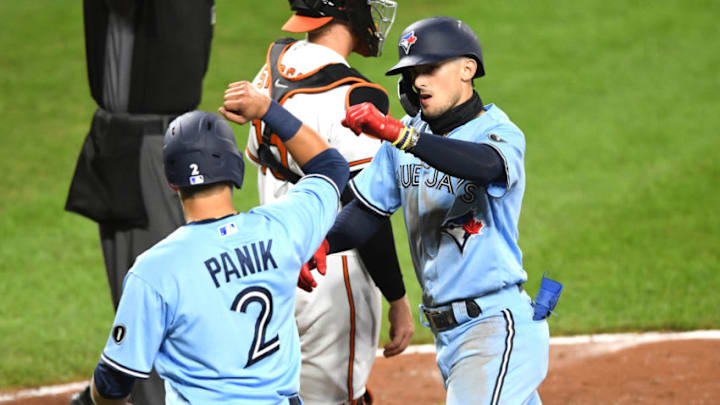 Former St. John's baseball star Joe Panik greets his teammate at home plate. (Photo by Mitchell Layton/Getty Images)