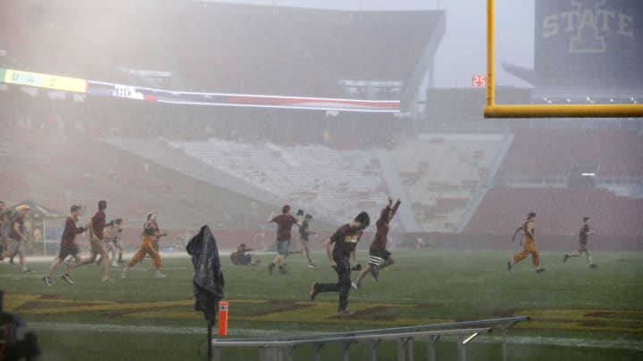 AMES, IA – SEPTEMBER 14: Iowa State Cyclones students run onto the football field during a thunderstorm at Jack Trice Stadium on September 14, 2019 in Ames, Iowa. The game was delayed between the Iowa Hawkeyes and the Iowa State Cyclones because of lighting strikes. (Photo by David Purdy/Getty Images)