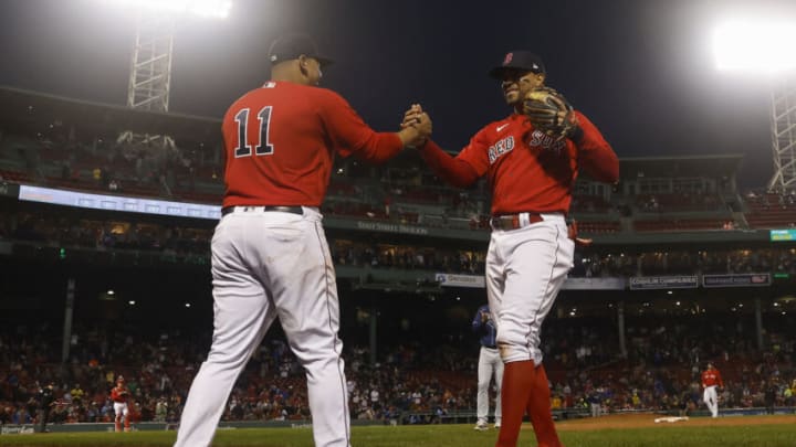 BOSTON, MA - OCTOBER 5: Xander Bogaerts #2 of the Boston Red Sox is greeted by teammate Rafael Devers #11 after he was removed from the game the seventh inning against the Tampa Bay Rays at Fenway Park on October 5, 2022 in Boston, Massachusetts. (Photo By Winslow Townson/Getty Images)