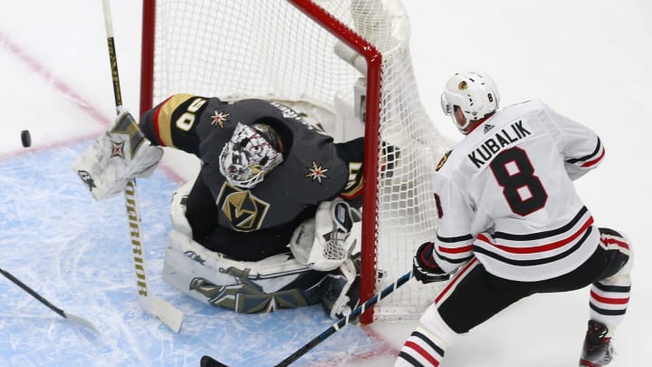 Robin Lehner #90 of the Vegas Golden Knights deflects a shot by Dominik Kubalik #8 of the Chicago Blackhawks in Game One of the Western Conference First Round.
