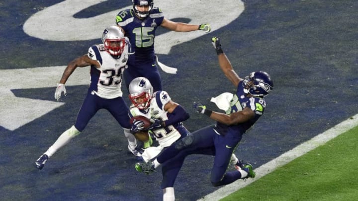 GLENDALE, AZ - FEBRUARY 01 : Malcolm Dutler #21 of the New England Patriots intercepts the pass at the goal line late in the fourth quarter against the Seattle Seahawks during Super Bowl XLIX February 1, 2015 at the University of Phoenix Stadium in Glendale, Arizona. The Patriots won the game 28-24. (Photo by Focus on Sport/Getty Images)