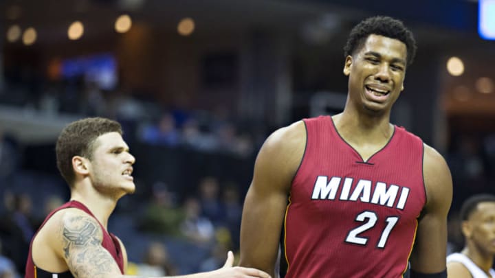 Hassan Whiteside #21 is restrained by Tyler Johnson #8 of the Miami Heat after being called for a foul (Photo by Wesley Hitt/Getty Images)
