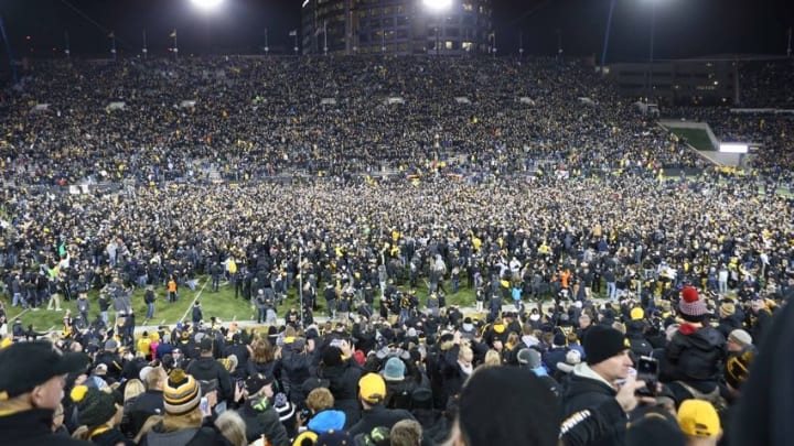 Nov 12, 2016; Iowa City, IA, USA; Fans storm the field after Iowa Hawkeyes place kicker Keith Duncan (not pictured) kicks the game winning field goal against the Michigan Wolverines at Kinnick Stadium. The Hawkeyes won 14-13. Mandatory Credit: Reese Strickland-USA TODAY Sports