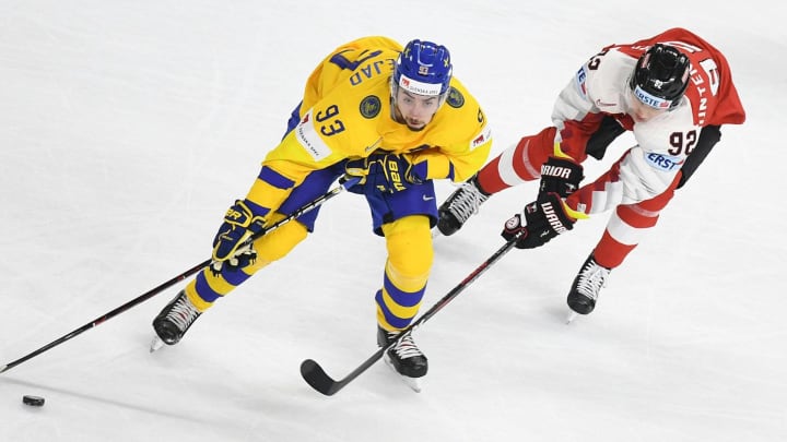 Sweden’s Mika Zibanejad (L) and Austria’s Clemens Unterweger vie for the puck during the group A match Sweden vs Austria of the 2018 IIHF Ice Hockey World Championship in Copenhagen, Denmark, on May 9, 2018. (Photo by HELMUT FOHRINGER / APA / AFP) / Austria OUT (Photo credit should read HELMUT FOHRINGER/AFP/Getty Images)