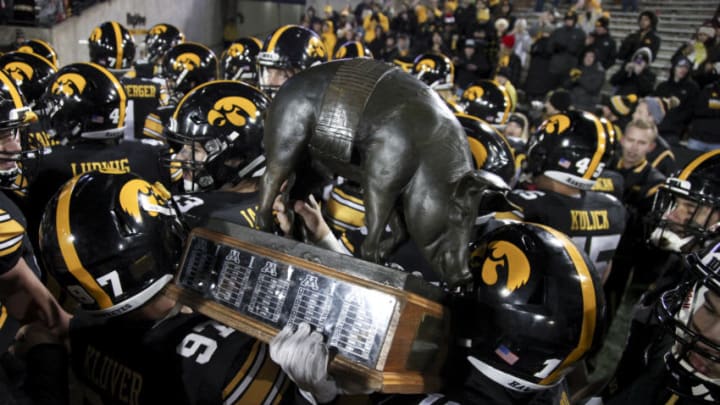 IOWA CITY, IOWA- OCTOBER 28: Defensive back Miles Taylor #19 and long snapper Tyler Kluver #97 of the Iowa Hawkeyes carry the Floyd of Rosedale trophy off the field after defeating the Minnesota Golden Gophers on October 28, 2017 at Kinnick Stadium in Iowa City, Iowa. (Photo by Matthew Holst/Getty Images)