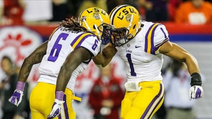 Dec 31, 2012; Atlanta, GA, USA; LSU Tigers safety Craig Loston (6) celebrates with safety Eric Reid (1) after a fumble recovery in the first half against the Clemson Tigers during the Chick-fil-A Bowl at the Georgia Dome. Mandatory Credit: Daniel Shirey-USA TODAY Sports