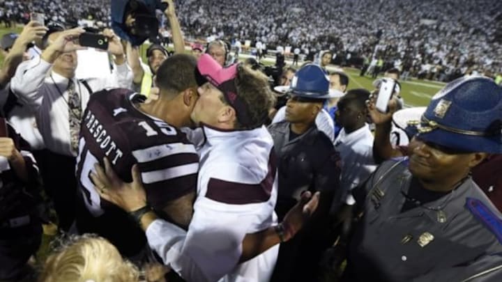 Oct 11, 2014; Starkville, MS, USA; Mississippi State Bulldogs head coach Dan Mullen gives Mississippi State Bulldogs quarterback Dak Prescott (15) a kiss as they celebrate their 38-23 victory over the Auburn Tigers at Davis Wade Stadium. Mandatory Credit: John David Mercer-USA TODAY Sports