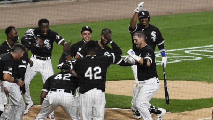 CHICAGO, ILLINOIS - AUGUST 28: The White Sox celebrate Yasmani Grandal's #42 walk off home run during the ninth inning against the Kansas City Royals. The White Sox won 6-5. All players are wearing #42 in honor of Jackie Robinson Day. The day honoring Jackie Robinson, traditionally held on April 15, was rescheduled due to the COVID-19 pandemic on August 28, 2020 in Chicago, Illinois. (Photo by David Banks/Getty Images)
