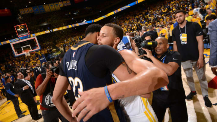 OAKLAND, CA - MAY 8: Anthony Davis #23 of the New Orleans Pelicans and Stephen Curry #30 of the Golden State Warriors hug after Game Five of the Western Conference Semifinals during the 2018 NBA Playoffs on May 8, 2018 at ORACLE Arena in Oakland, California. NOTE TO USER: User expressly acknowledges and agrees that, by downloading and/or using this photograph, user is consenting to the terms and conditions of Getty Images License Agreement. Mandatory Copyright Notice: Copyright 2018 NBAE (Photo by Noah Graham/NBAE via Getty Images)