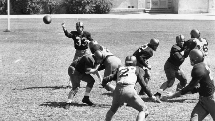 1950S: Quarterback Sammy Baugh #33 of the Washington Redskins throws a pass during practice drills circa 1950’s. (Photo by Nate Fine/Getty Images)