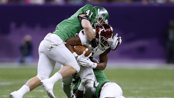 NEW ORLEANS, LA – DECEMBER 16: Colton McDonald #41 of the North Texas Mean Green and Ashton Preston #27 tackle John Johnson #2 of the Troy Trojans in the first half during the R+L Carriers New Orleans Bowl at the Mercedes-Benz Superdome on December 16, 2017 in New Orleans, Louisiana. (Photo by Jonathan Bachman/Getty Images)