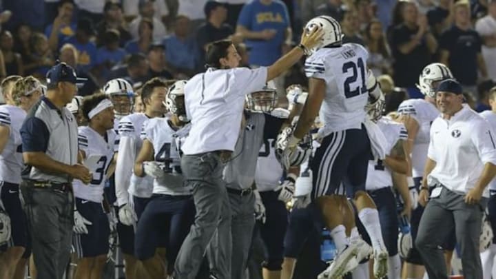 Sep 19, 2015; Pasadena, CA, USA; Brigham Young Cougars linebacker Harvey Langi (21) is greeted at the sideline after an interception in the second quarter of the game against the UCLA Bruins at the Rose Bowl. Mandatory Credit: Jayne Kamin-Oncea-USA TODAY Sports