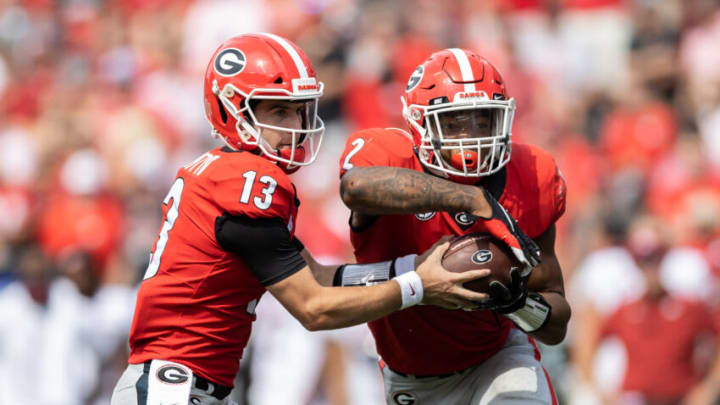 Stetson Bennett hands the ball to Kendall Milton during the Arkansas game. (Photo by Steven Limentani/ISI Photos/Getty Images)