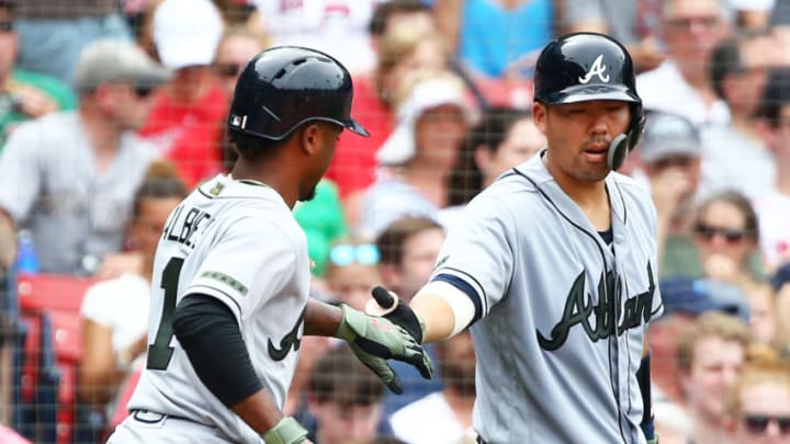 BOSTON, MA - MAY 26: Ozzie Albies #1 high fives Kurt Suzuki #24 of the Atlanta Braves after scoring in the fourth inning of a game against the Boston Red Sox at Fenway Park on May 26, 2018 in Boston, Massachusetts. (Photo by Adam Glanzman/Getty Images)