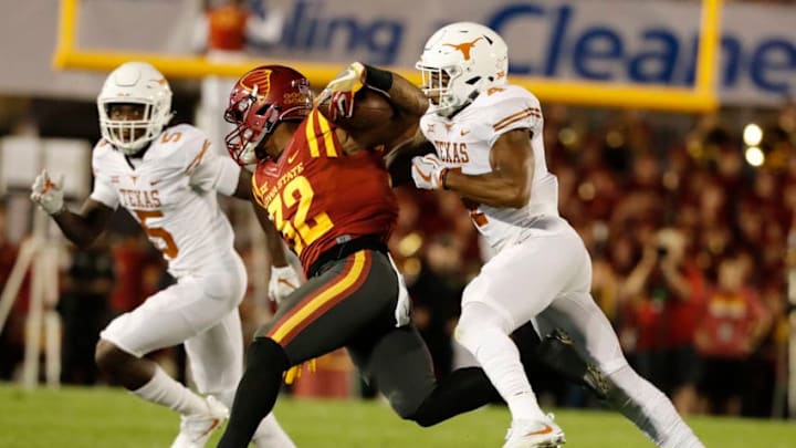 AMES, IA - SEPTEMBER 28: Running back David Montgomery #32 of the Iowa State Cyclones is tackled by defensive back DeShon Elliott #4, and defensive back Holton Hill #5 of the Texas Longhorns as he rushed for yards in the first half of play at Jack Trice Stadium on September 28, 2017 in Ames, Iowa. (Photo by David Purdy/Getty Images)