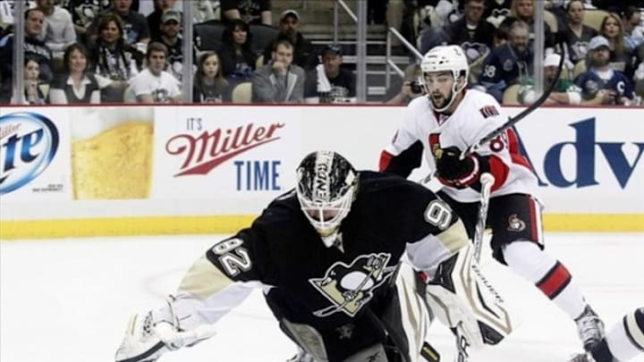 May 14, 2013; Pittsburgh, PA, USA; Pittsburgh Penguins goalie Tomas Vokoun (92) dives to make a save as Ottawa Senators left wing Cory Conacher (89) looks for a rebound during the first period in game one of the second round of the 2013 Stanley Cup Playoffs at the CONSOL Energy Center. Mandatory Credit: Charles LeClaire-USA TODAY Sports
