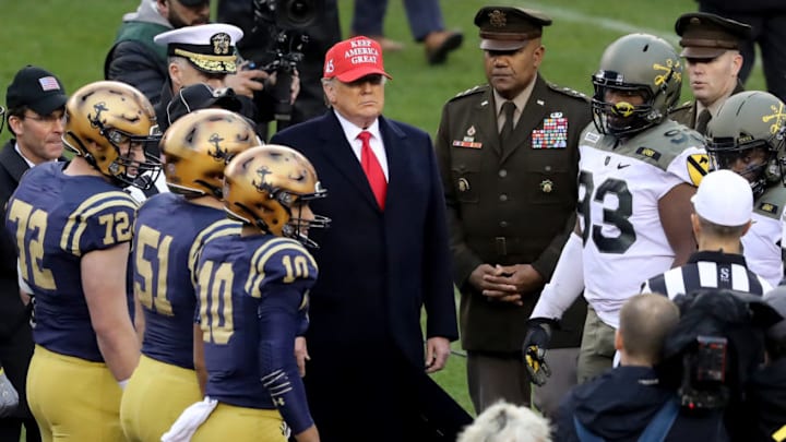 PHILADELPHIA, PENNSYLVANIA - DECEMBER 14: U.S. President Donald Trump participates in the coin toss before the game between the Army Black Knights and the Navy Midshipmen. (Photo by Elsa/Getty Images)