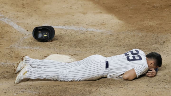 NEW YORK, NEW YORK - APRIL 07: Gio Urshela #29 of the New York Yankees lies on the ground after he is tagged out sliding into home during the eleventh inning against the Baltimore Orioles at Yankee Stadium on April 07, 2021 in the Bronx borough of New York City. The Orioles won 4-3. (Photo by Sarah Stier/Getty Images)