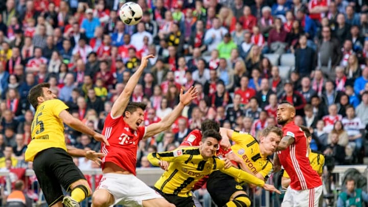 MUNICH, GERMANY - APRIL 08: Robert Lewandowski of Bayern Muenchen in action against Marc Aregall Bartra (M) of Dortmund and Sokratis of Dortmund (L) during the Bundesliga match between Bayern Muenchen and Borussia Dortmund at Allianz Arena on April 8, 2017 in Munich, Germany. (Photo by Alexander Scheuber/Getty Images Fuer MAN)