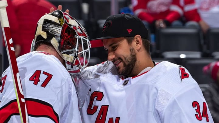 DETROIT, MI - NOVEMBER 24: Petr Mrazek #34 of the Carolina Hurricanes congratulates teammate James Reimer #47 after an NHL game against the Detroit Red Wings at Little Caesars Arena on November 24, 2019 in Detroit, Michigan. Carolina defeated Detroit 2-0. (Photo by Dave Reginek/NHLI via Getty Images)