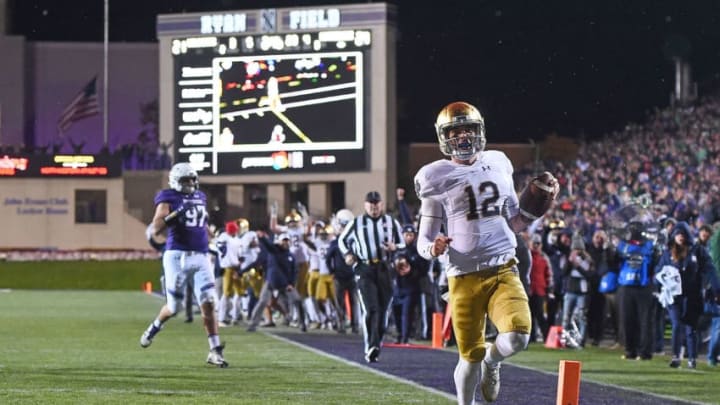 EVANSTON, IL - NOVEMBER 03: Ian Book #12 of the Notre Dame Fighting Irish rushes for a touchdown during the second half of a game against the Northwestern Wildcats at Ryan Field on November 3, 2018 in Evanston, Illinois. (Photo by Stacy Revere/Getty Images)