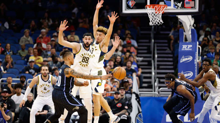 Feb 28, 2022; Orlando, Florida, USA; Orlando Magic guard Markelle Fultz (20) passes the ball past Indiana Pacers guard Chris Duarte (3) in the first quarter at Amway Center. Mandatory Credit: Nathan Ray Seebeck-USA TODAY Sports