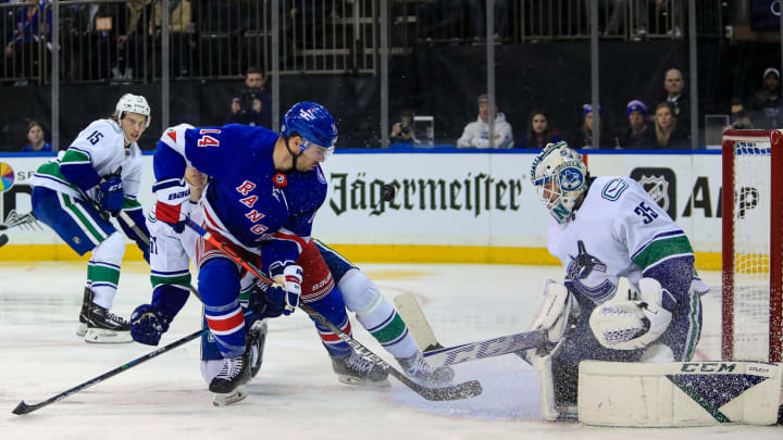 Feb 27, 2022; New York, New York, USA; Vancouver Canucks goalie Thatcher Demko (35) stops a shot by New York Rangers center Greg McKegg (14) during the second period at Madison Square Garden. Mandatory Credit: Danny Wild-USA TODAY Sports