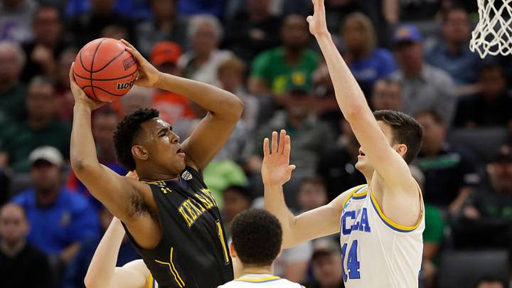 SACRAMENTO, CA - MARCH 17: Adonis De La Rosa #1 of the Kent State Golden Flashes is defended by Gyorgy Goloman #14 of the UCLA Bruins during the first round of the 2017 NCAA Men's Basketball Tournament at Golden 1 Center on March 17, 2017 in Sacramento, California. (Photo by Jamie Squire/Getty Images)